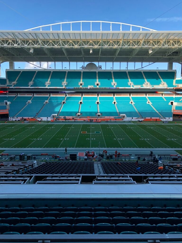 Empty field and blue seating inside Hard Rock Stadium, home of the Miami Dolphins
