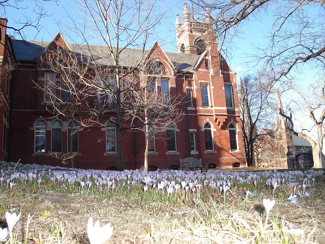 Red brick building and crocuses on the Smith College campus in Northampton, Massachusetts
